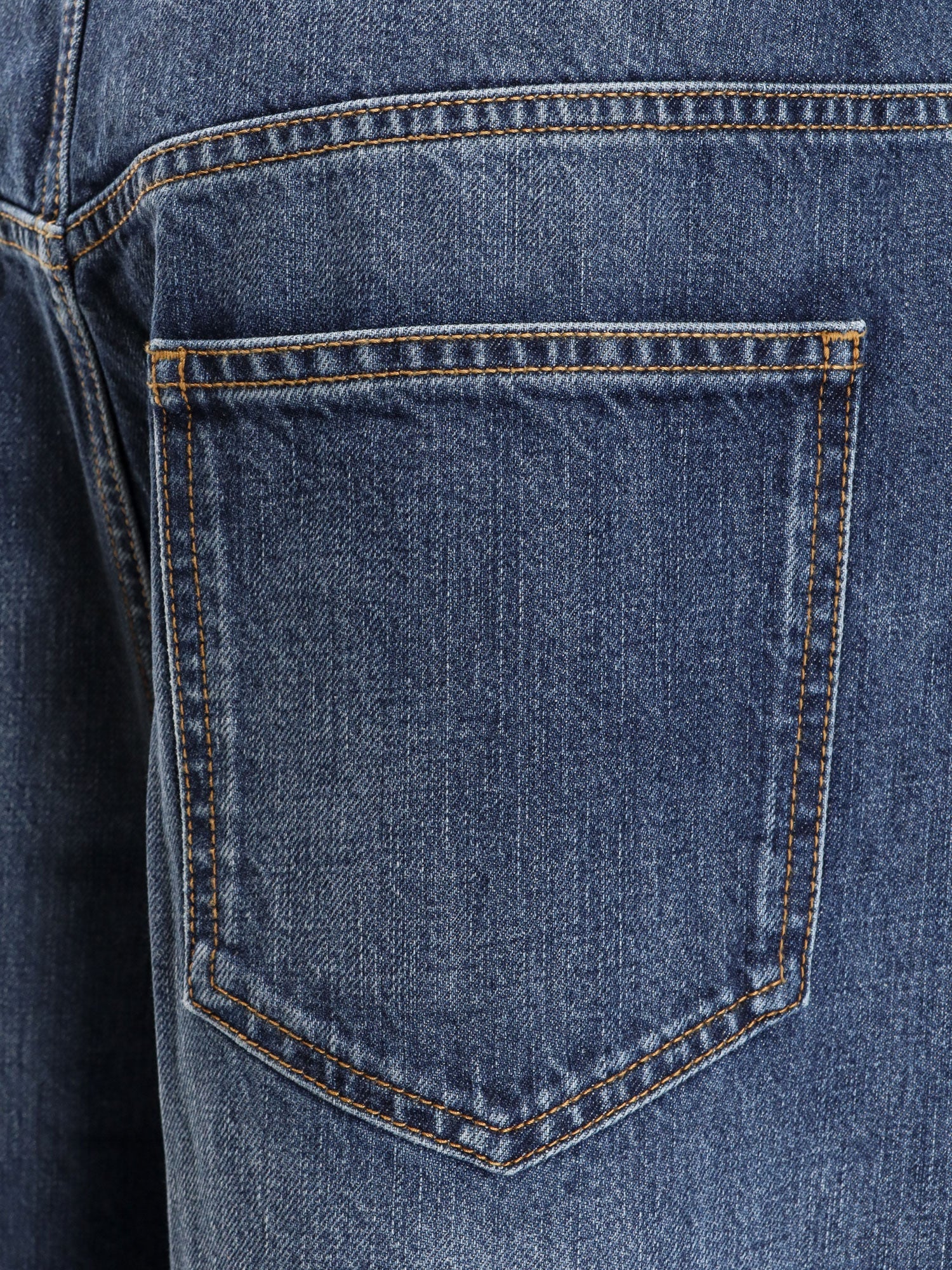 Twisted stone-washed denim jeans