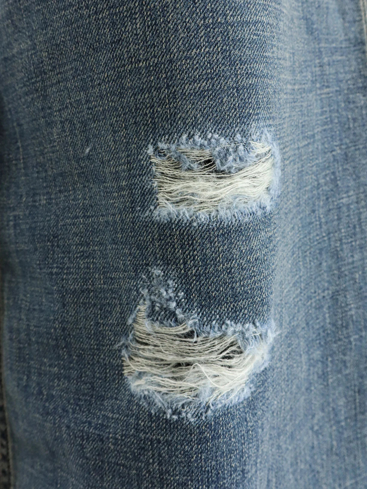 Destroyed-effect blue denim jeans