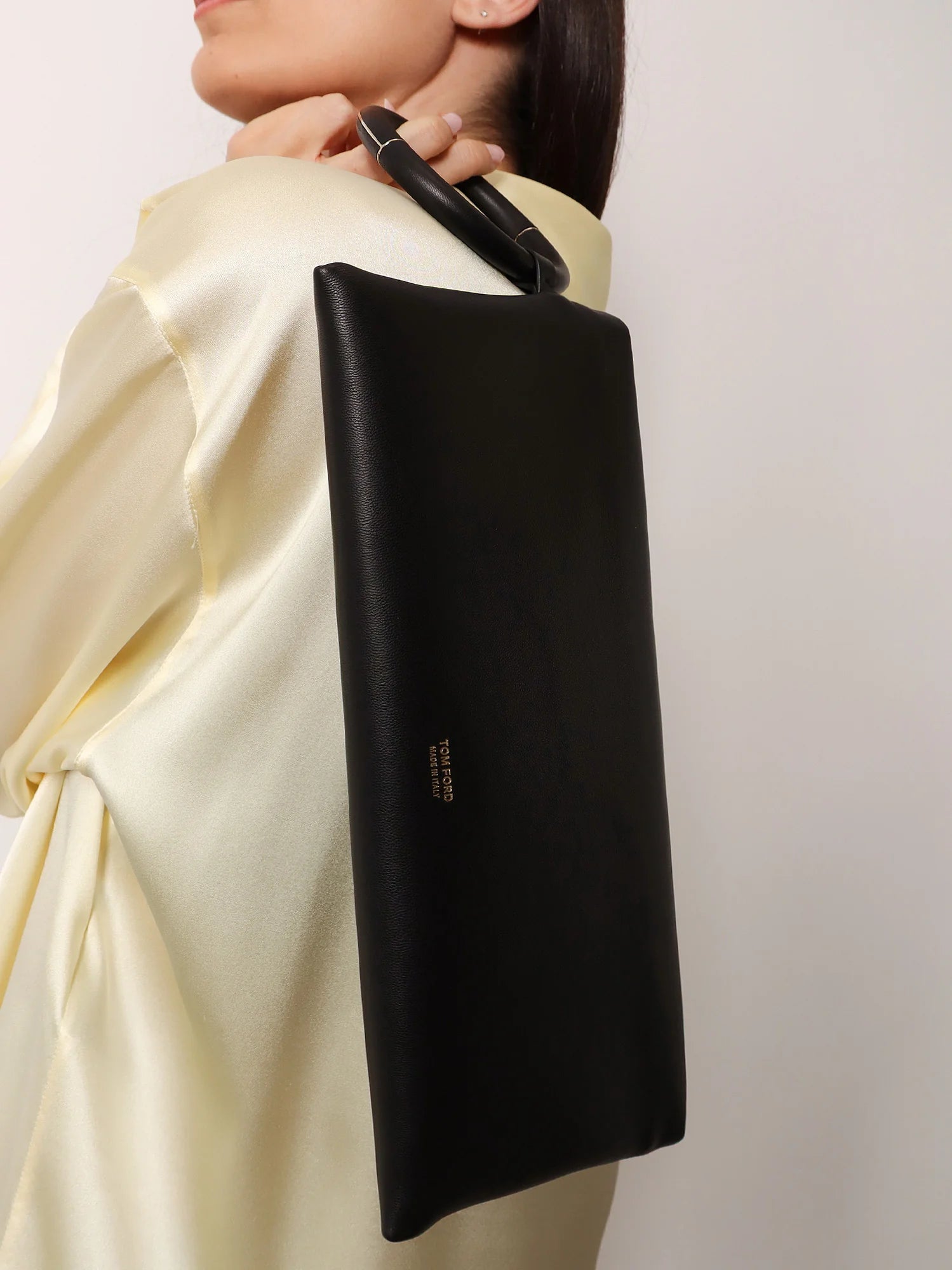 Aura leather clutch bag with lettering logo on the front