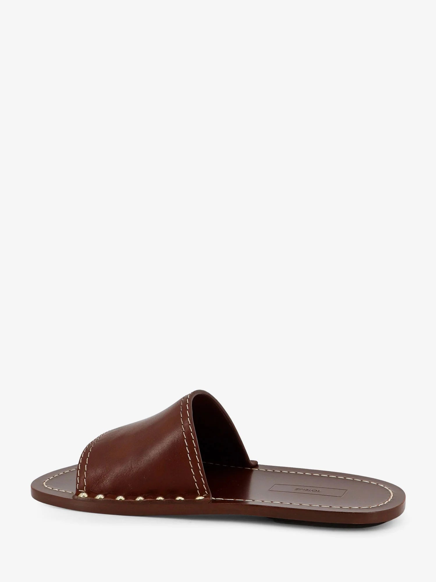 Low leather sandals with metal studs on the sides