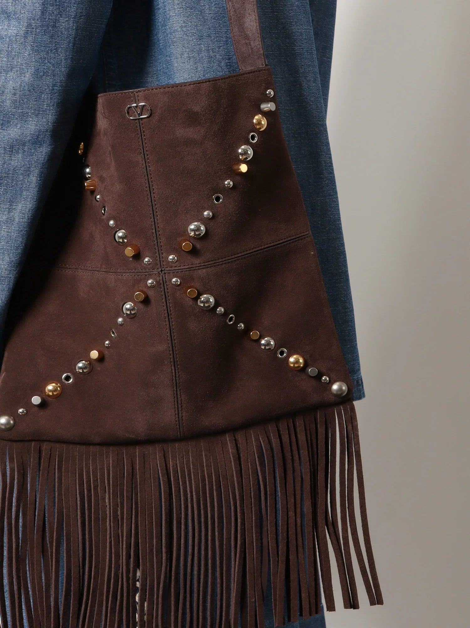 Suede shoulder bag with fringes and metal details