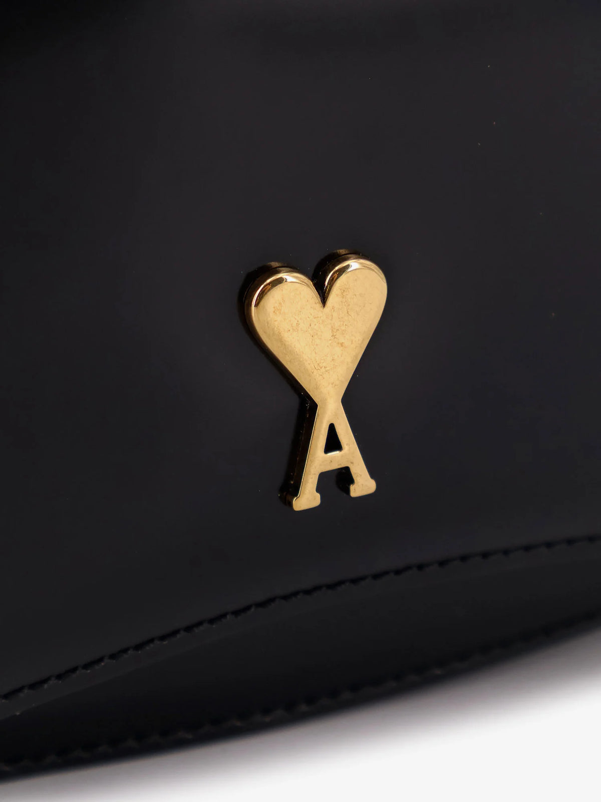 Leather shoulder bag with metal logo on the front