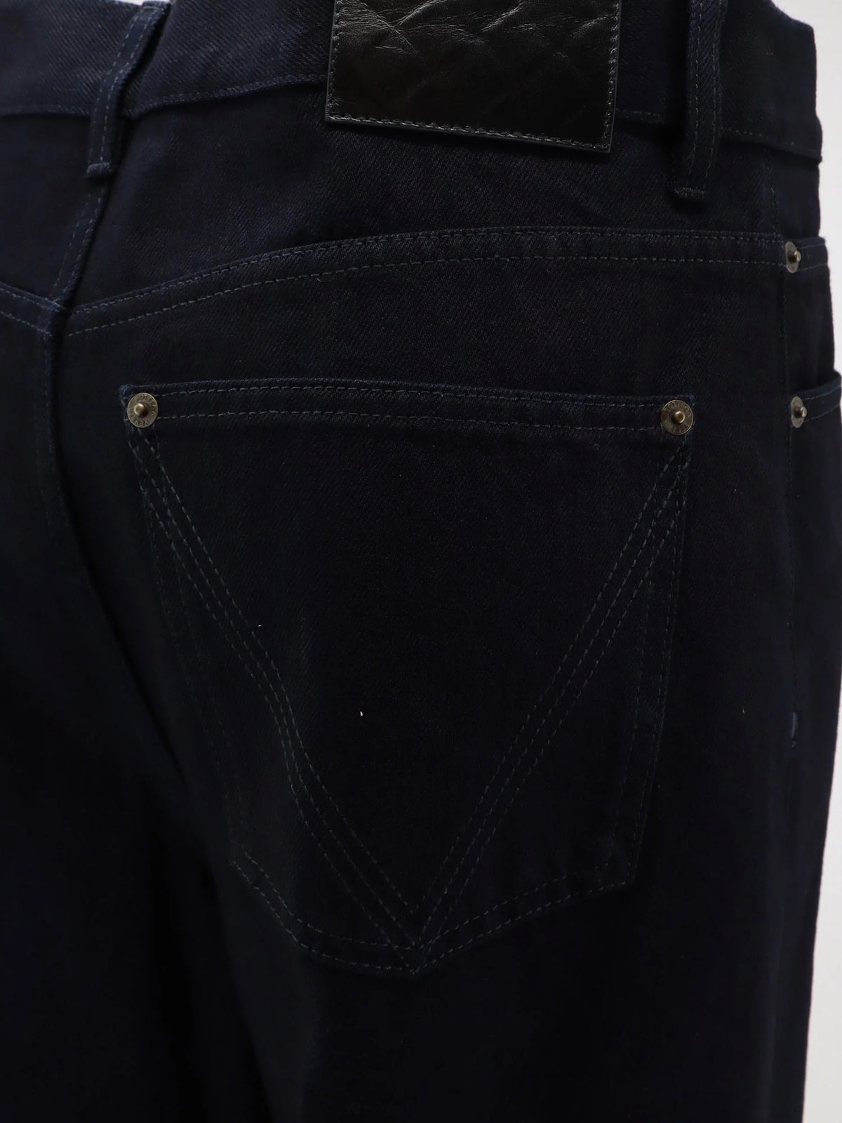 Jeans with leather patch with embossed Intrecciato motif