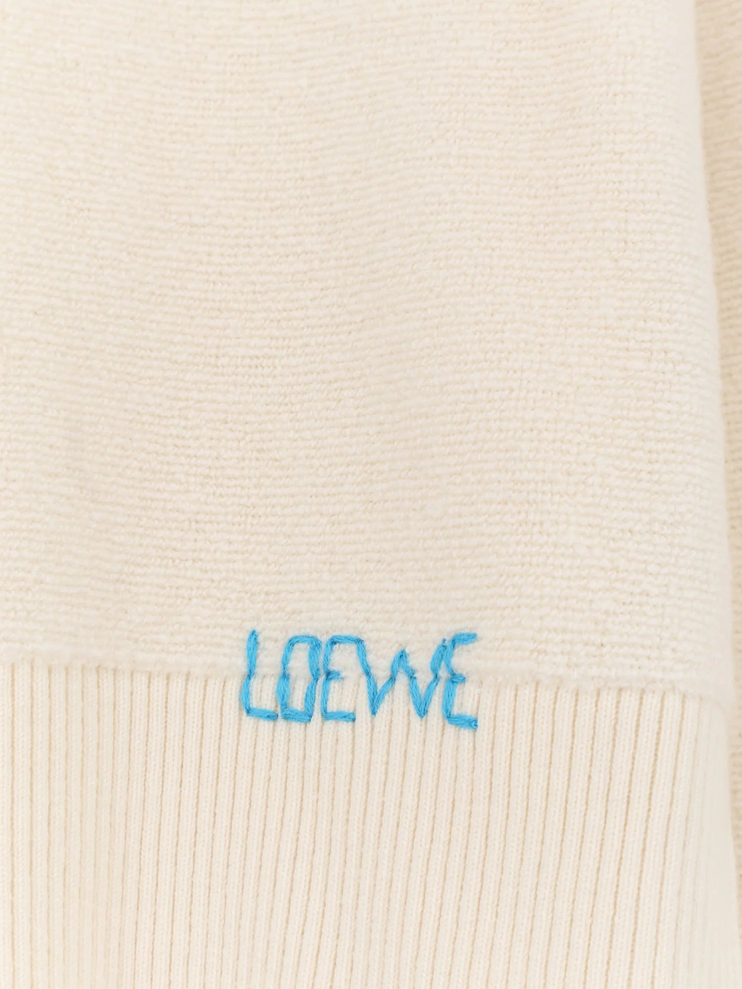 Wool sweater with contrasting embroidered logo on the bottom